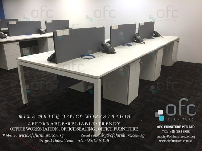 Office workstation setup featuring rows of white desks with grey partition panels, equipped with under-desk storage units